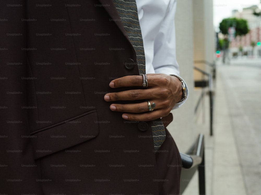 Un hombre con traje y corbata con la mano en la solapa