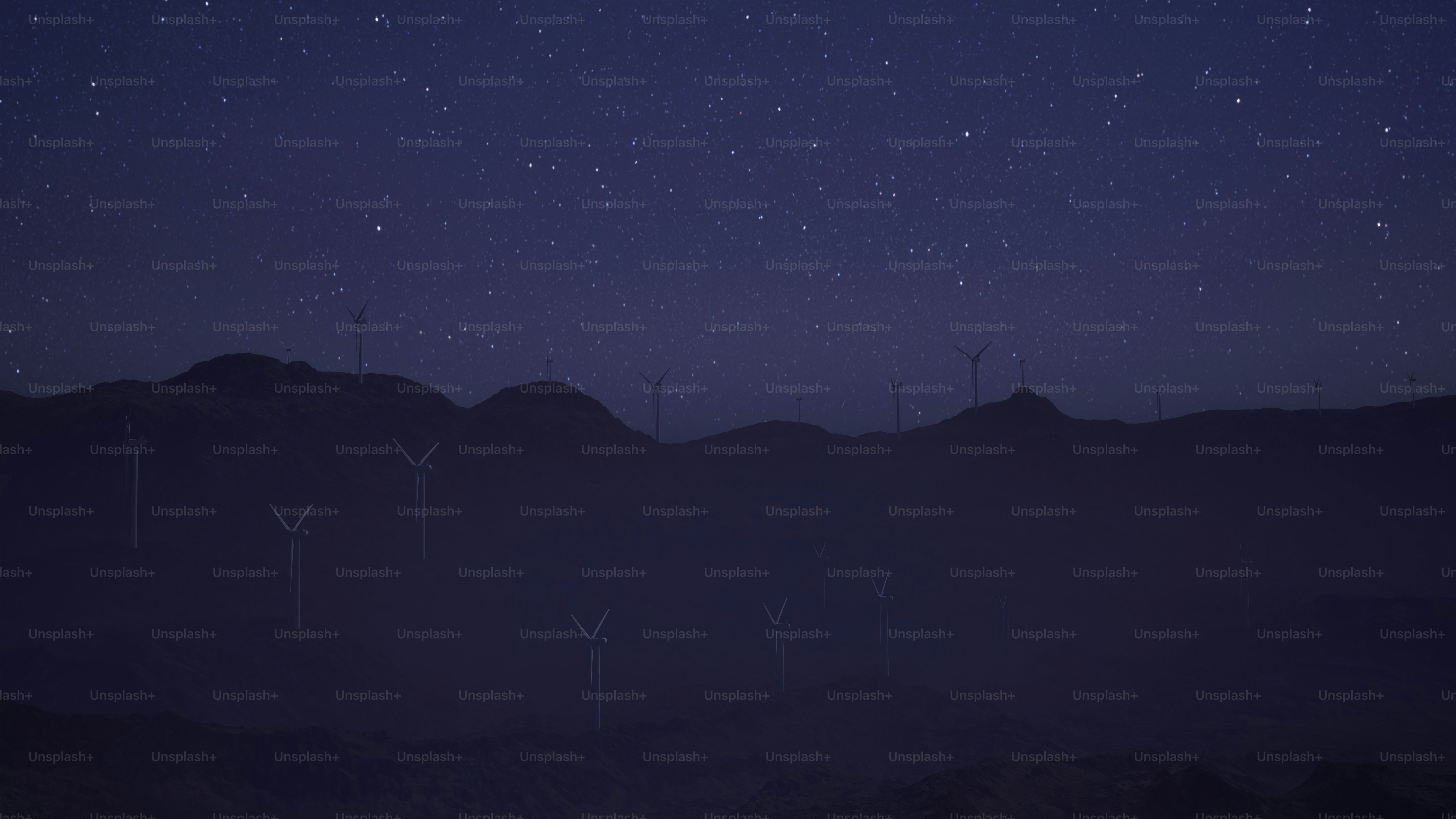 Un grupo de molinos de viento en una colina por la noche