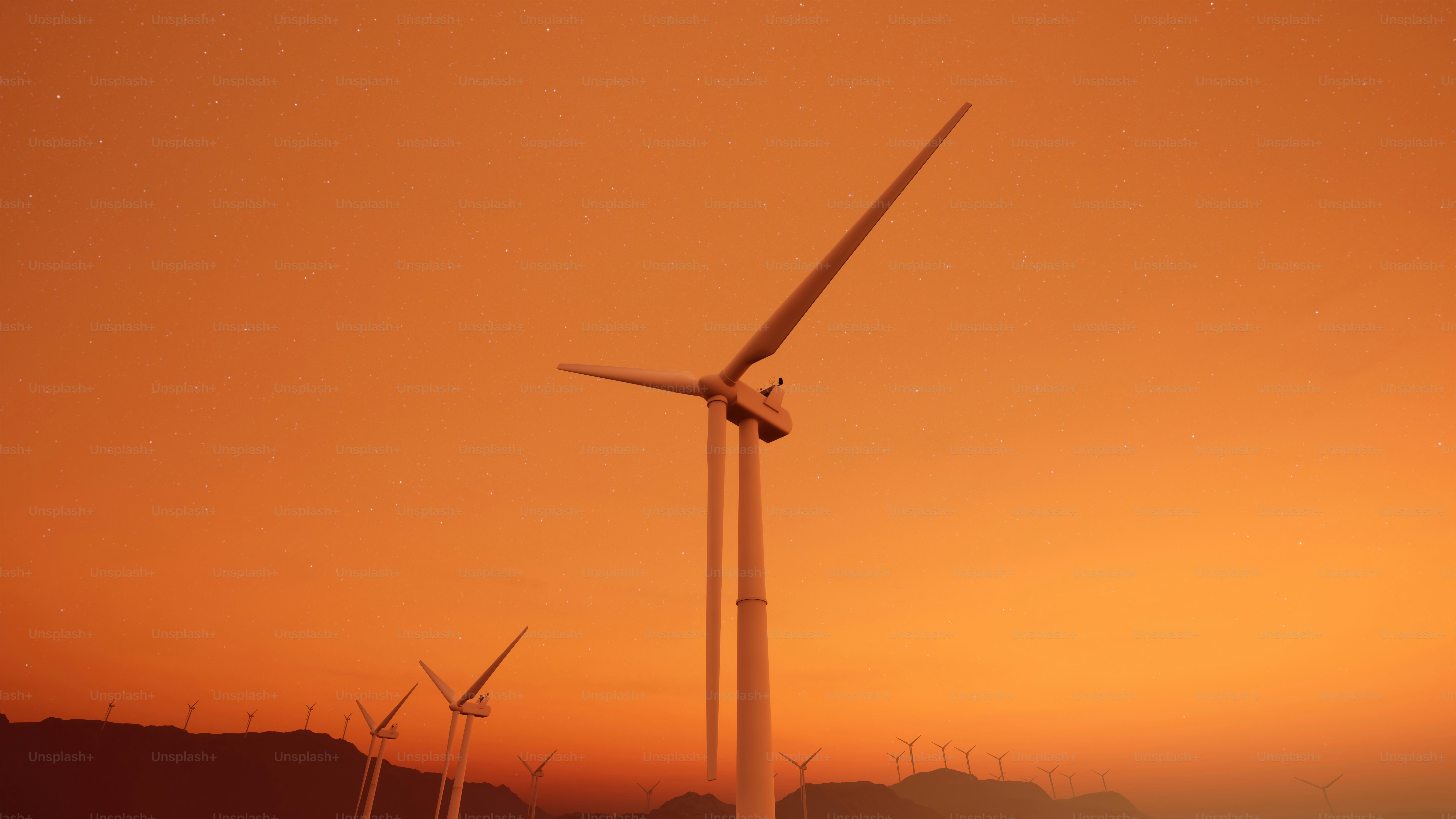 Un grupo de molinos de viento en un campo al atardecer
