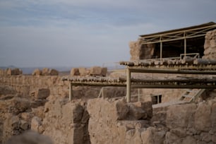 a stone wall with a metal structure in the middle of it