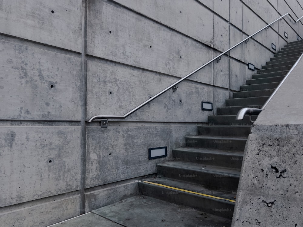 a set of stairs leading up to a cement wall