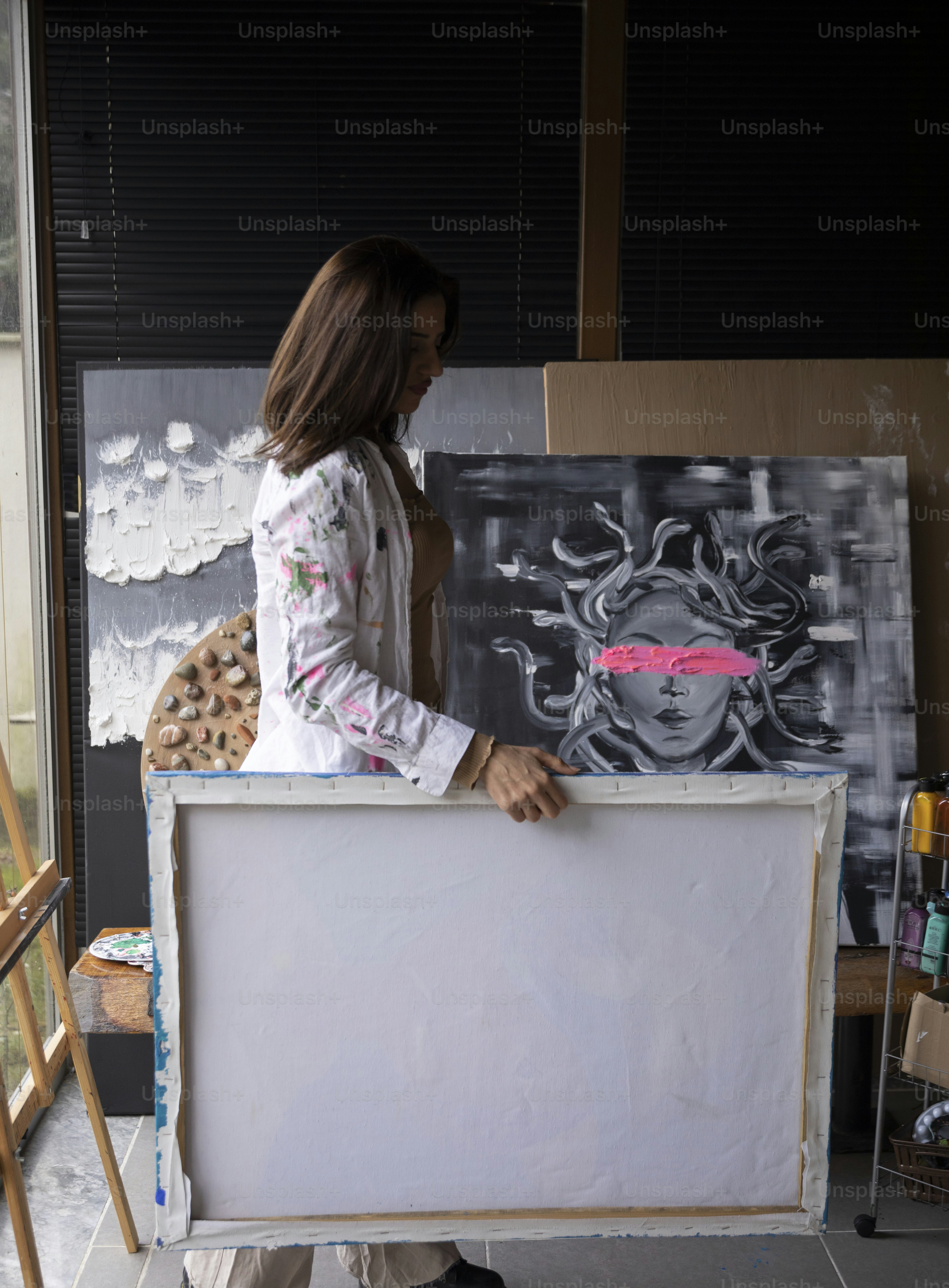 a woman is holding a large white board