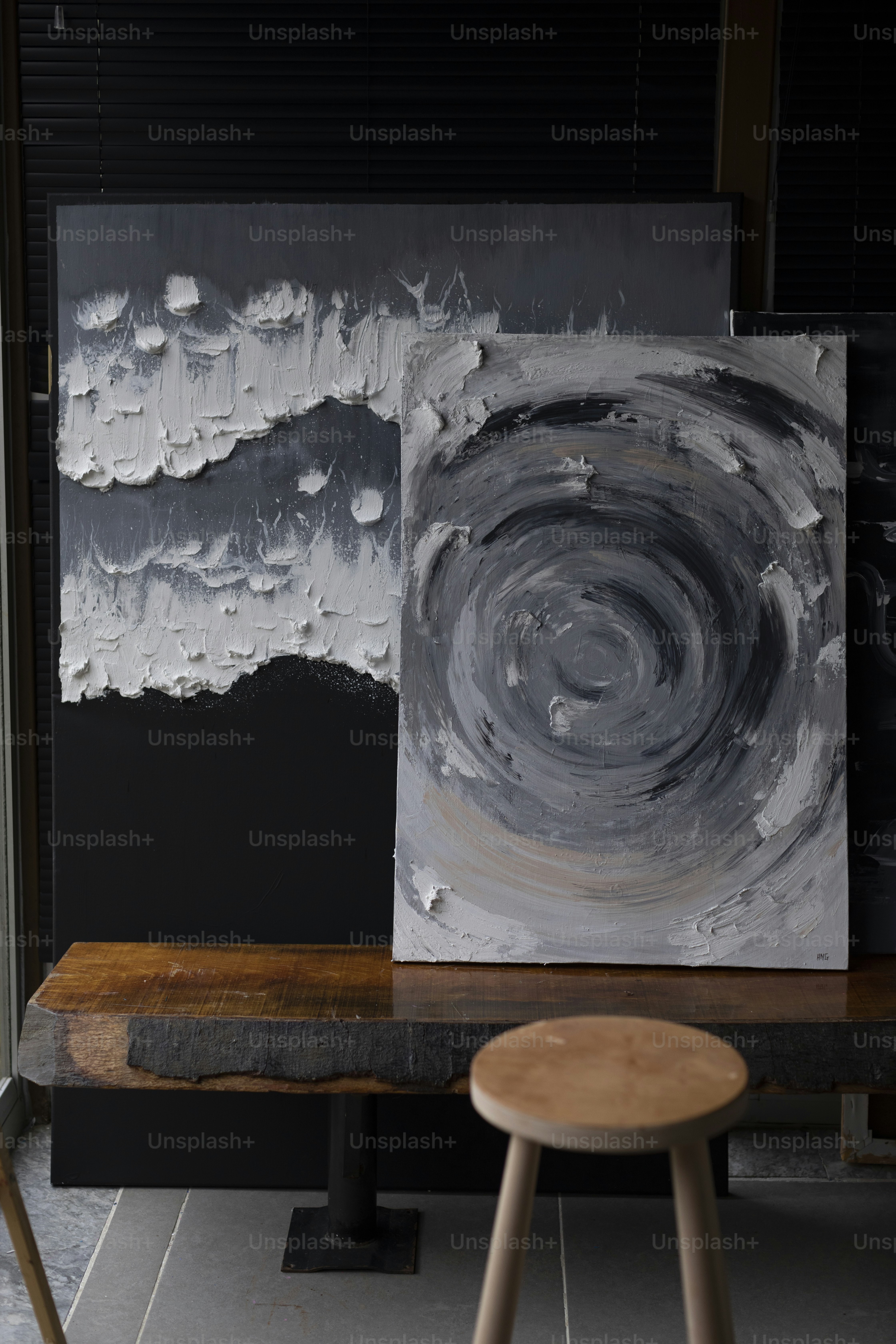 a painting on a table next to a stool