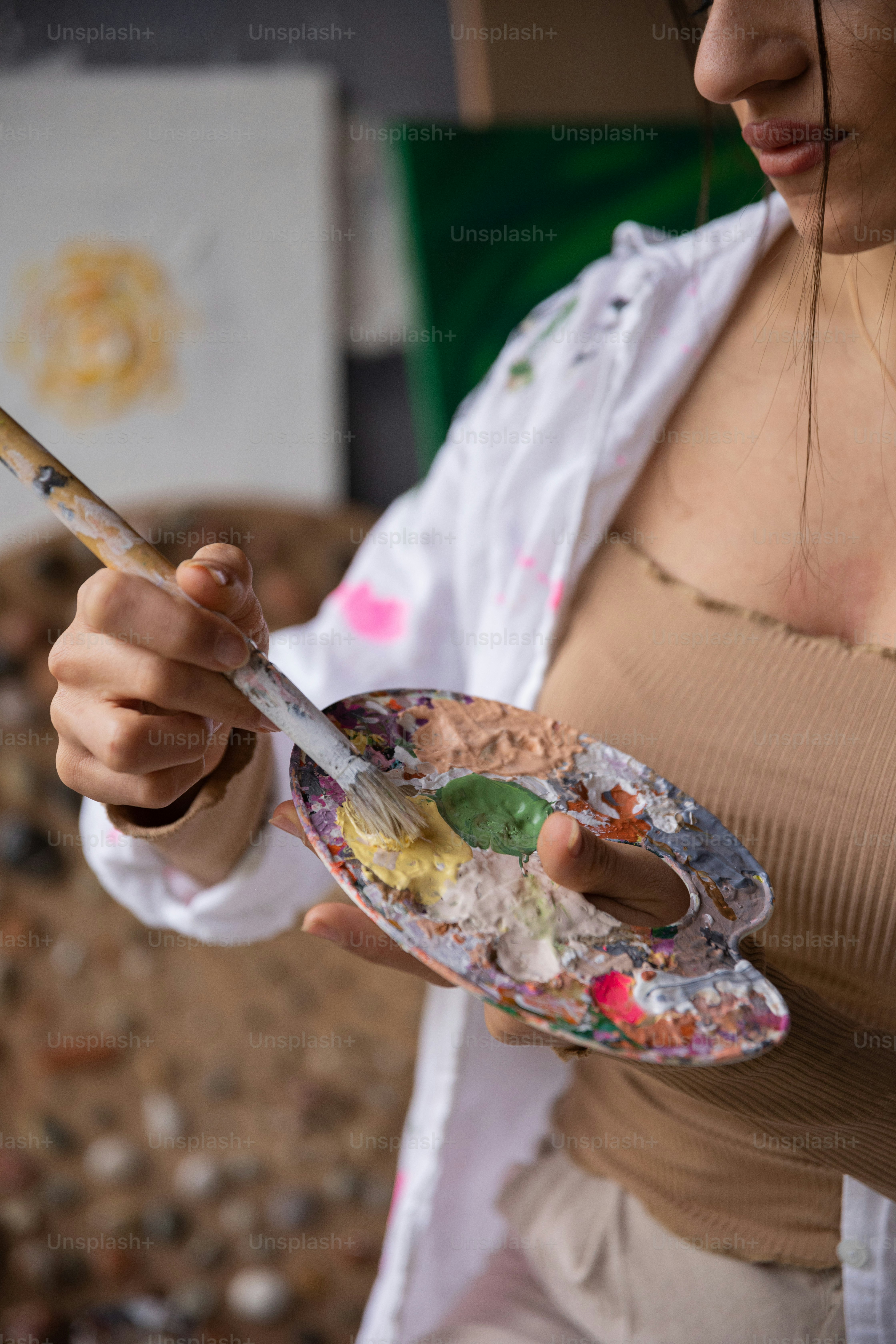 a woman holding a paintbrush and a palette
