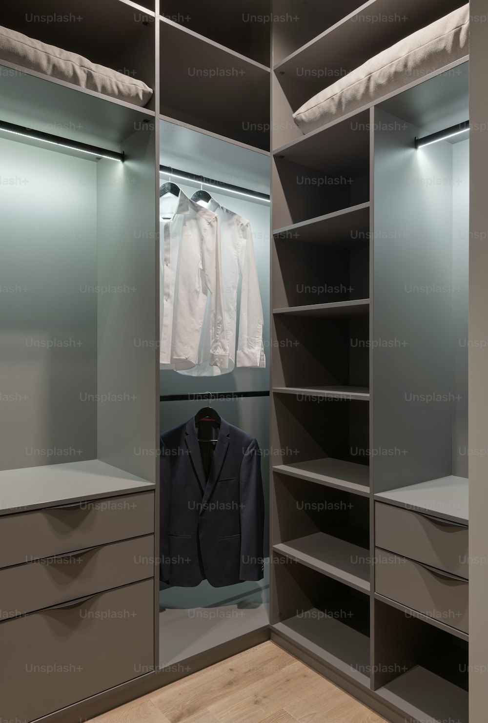 a walk in closet with a suit and jacket