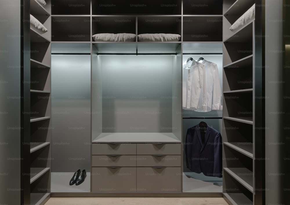 a walk in closet with a lot of shelves