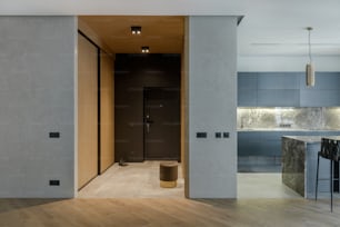 a kitchen with a wooden floor and gray walls