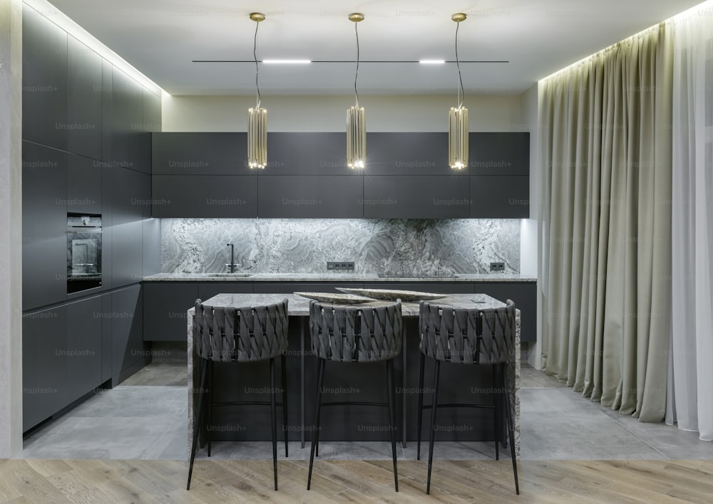 a modern kitchen with a marble counter top and bar stools