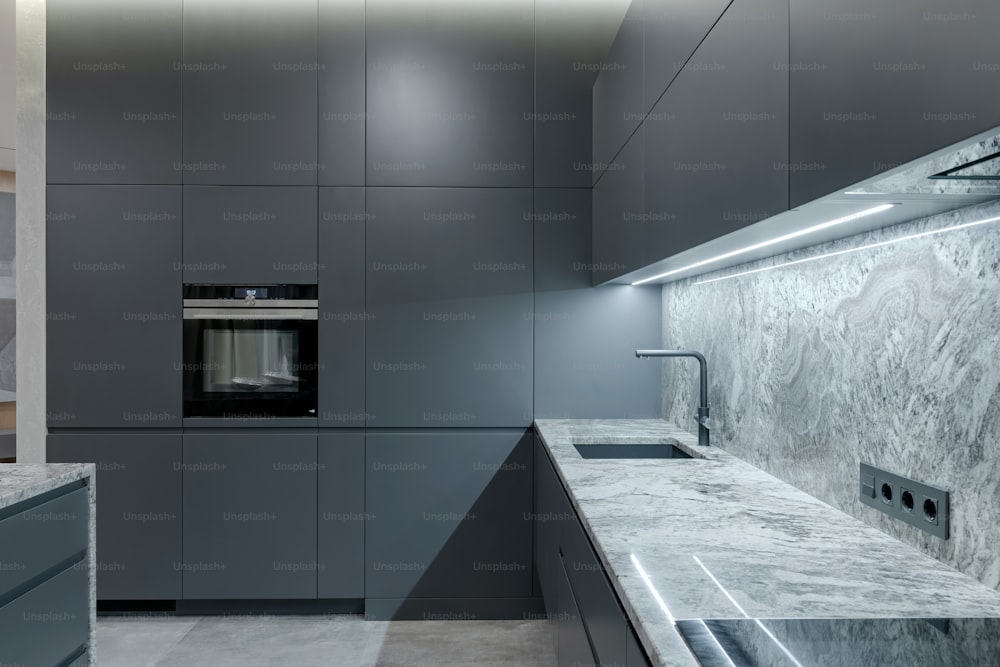 a modern kitchen with a marble counter top