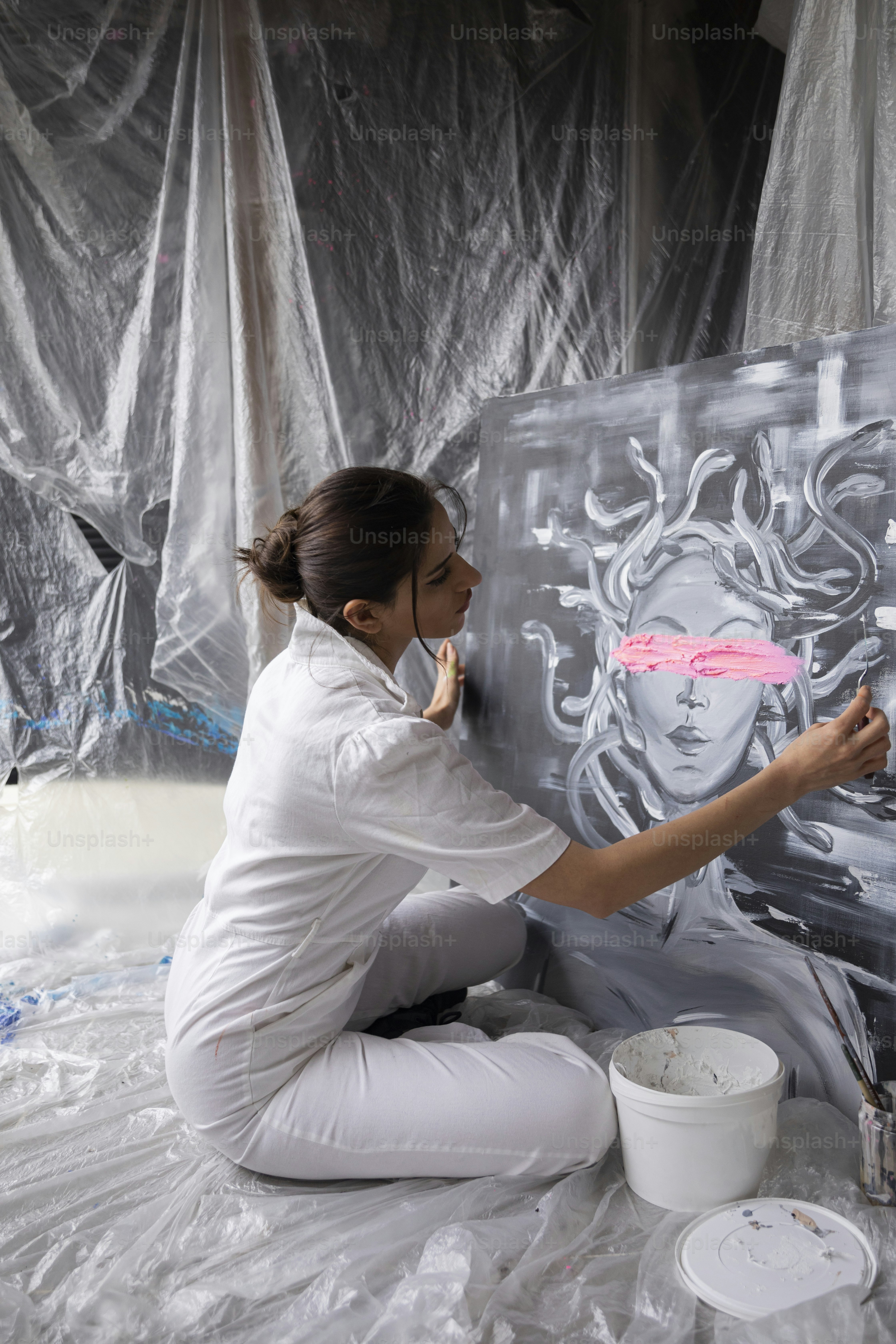 A woman is painting a picture on a canvas photo – Canvas painting Image ...