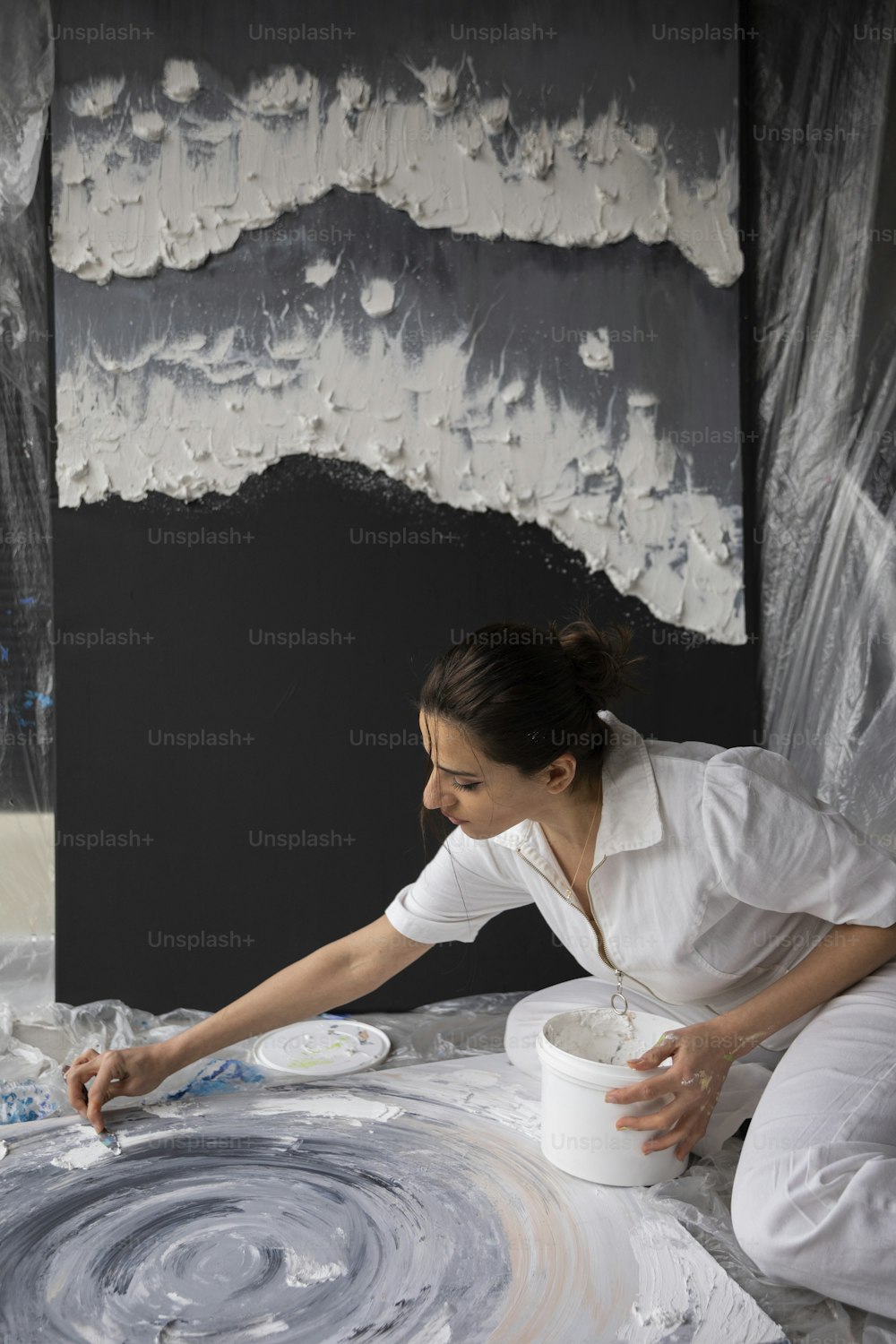 Una donna sta dipingendo un quadro su una tela