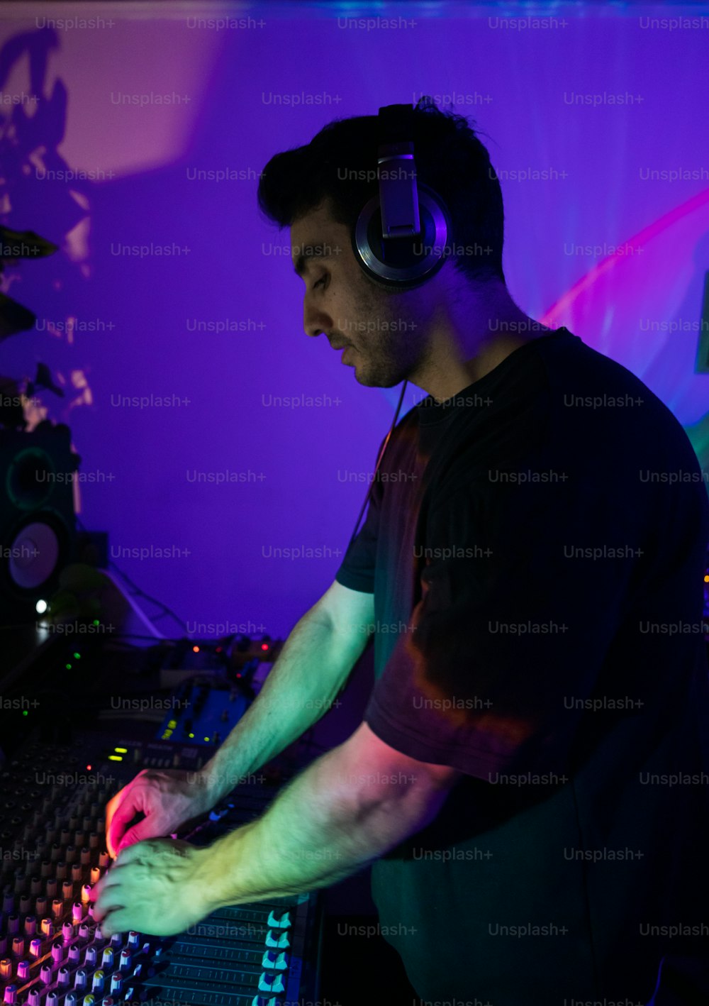 a man with headphones on mixing in a music studio