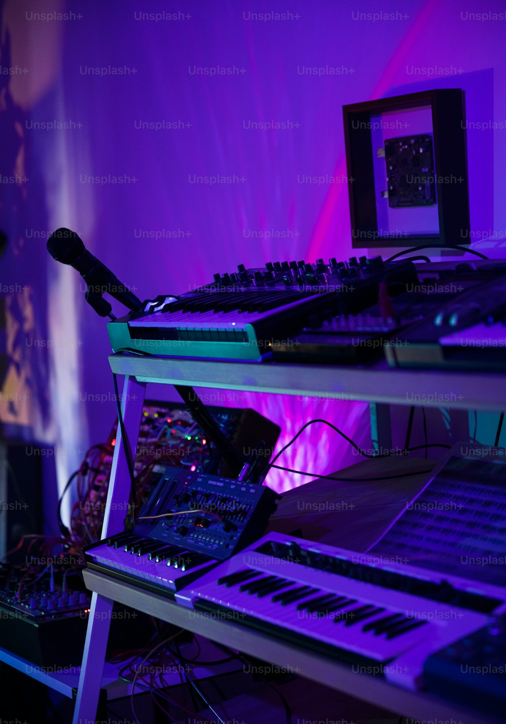 a music mixing desk with a keyboard and a monitor