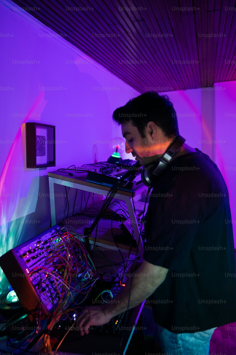 a man standing in front of a mixing desk