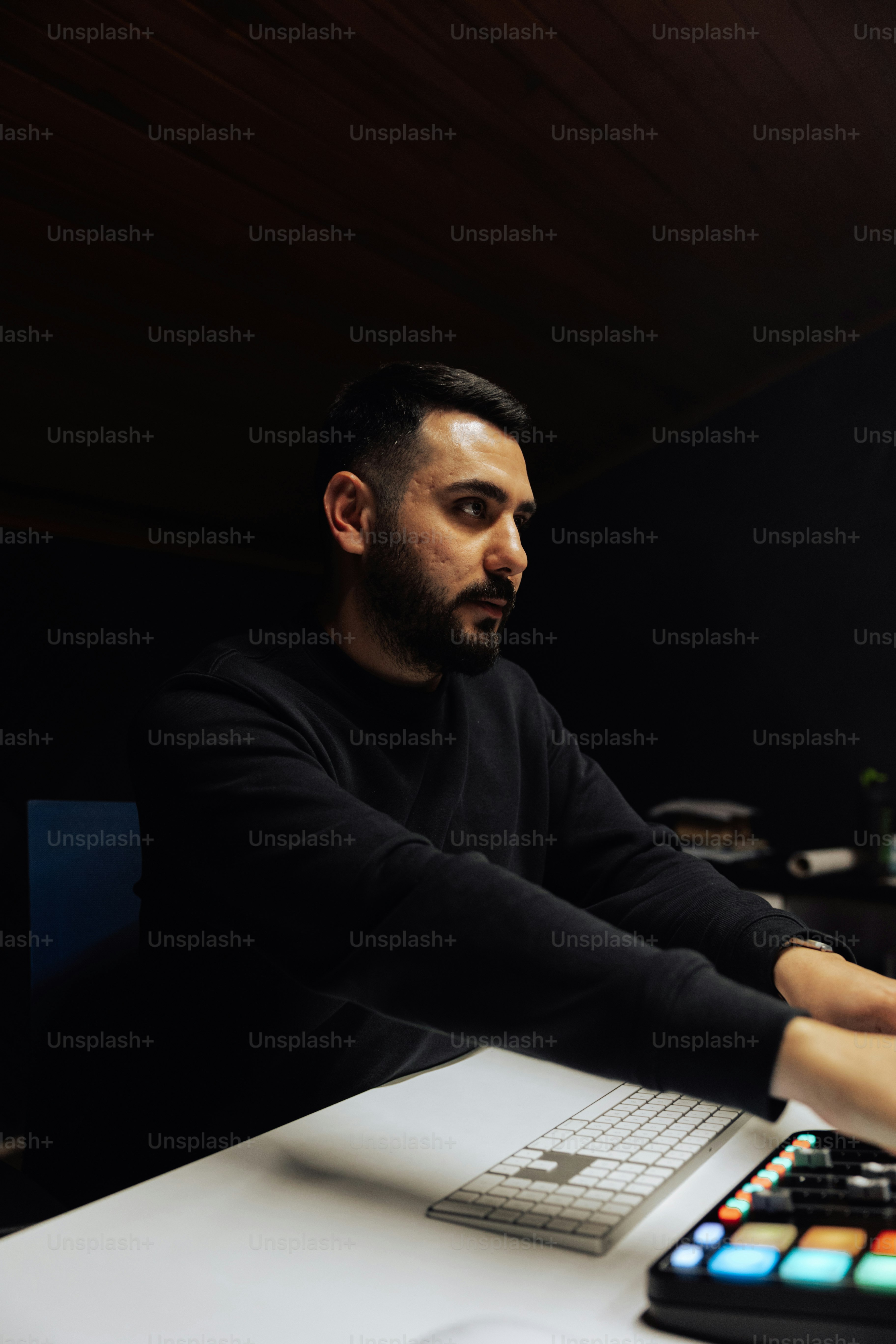 a man sitting in front of a laptop computer