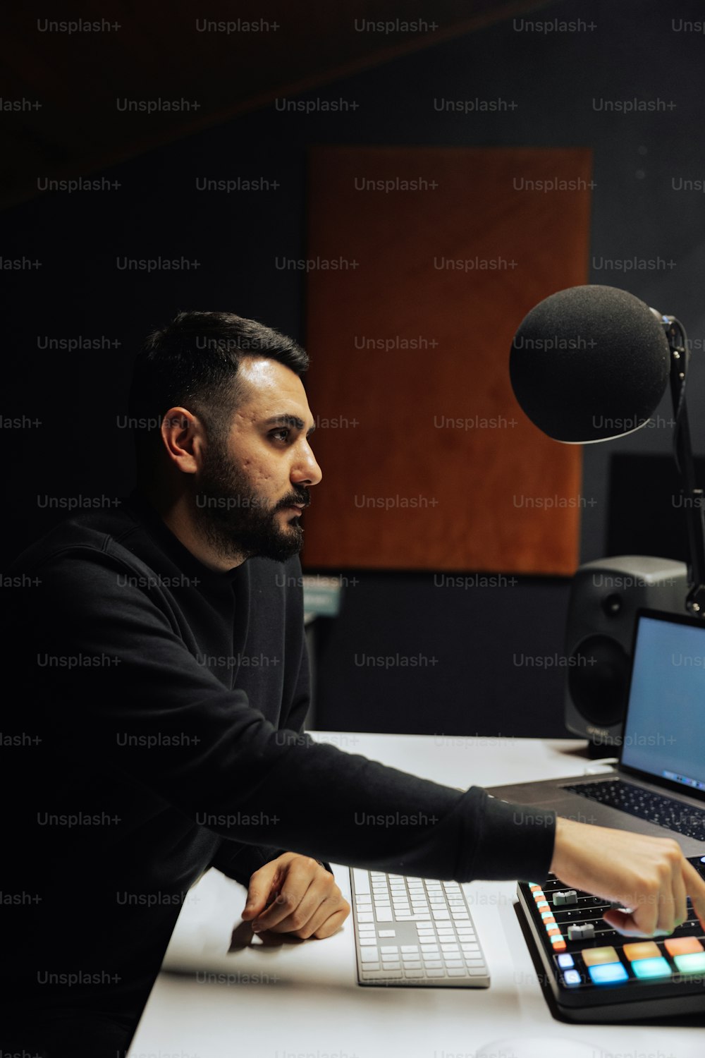 a man sitting in front of a laptop computer