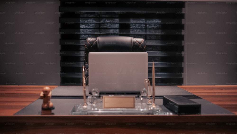 a laptop computer sitting on top of a wooden desk