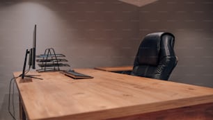 a desk with a chair and a computer on it