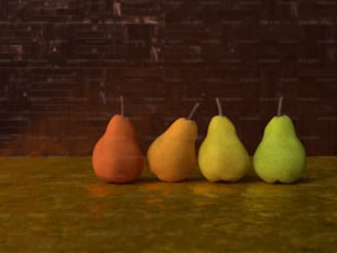 a row of four pears sitting on top of a counter