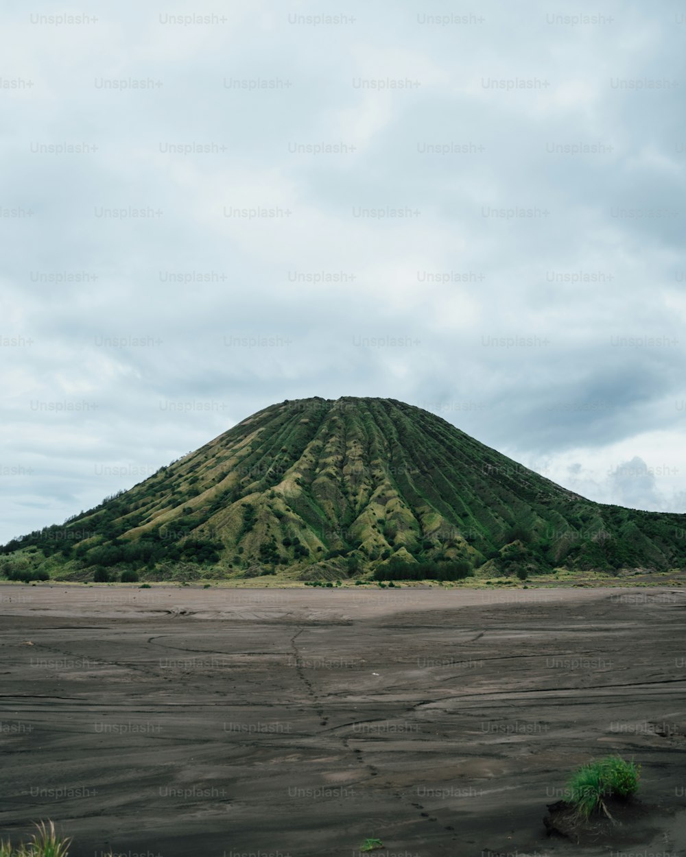 a very large mountain with a very tall hill in the background