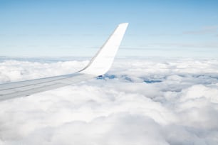 Der Flügel eines Flugzeugs über den Wolken