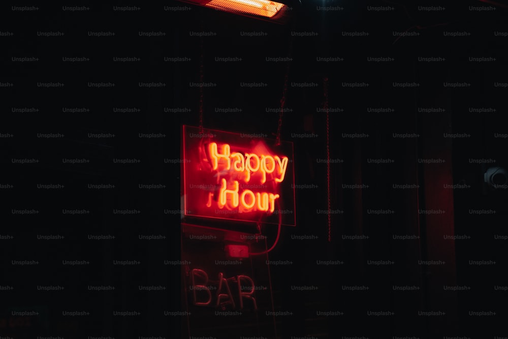 a happy hour bar sign lit up in the dark