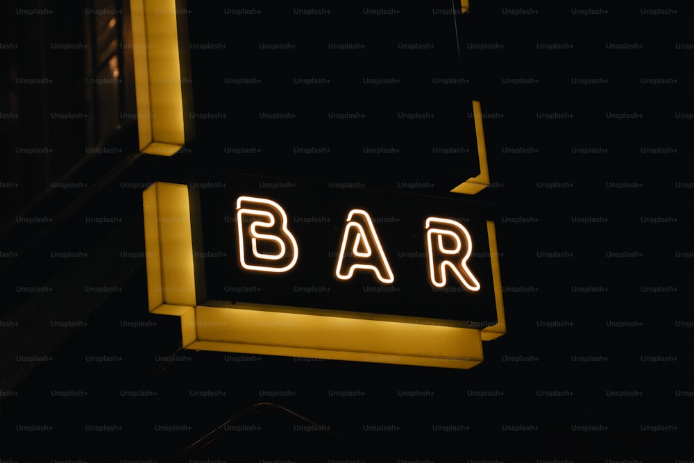 a bar sign lit up at night in the dark