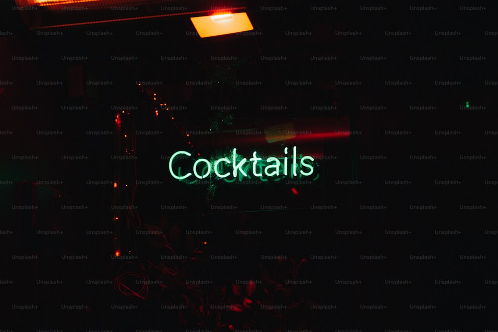 a neon sign that reads cocktails in a dark room