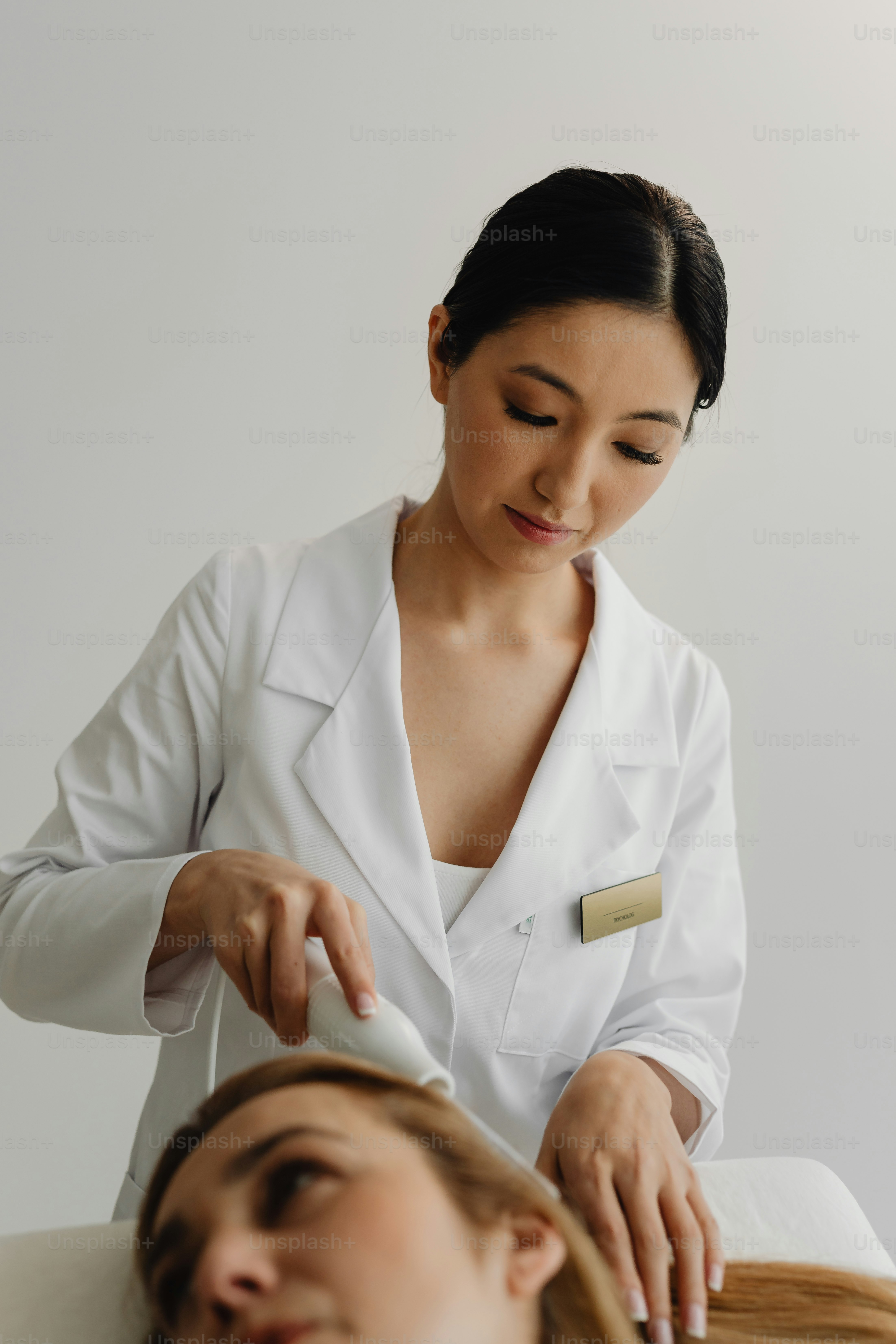 a woman getting her hair cut by a hair stylist