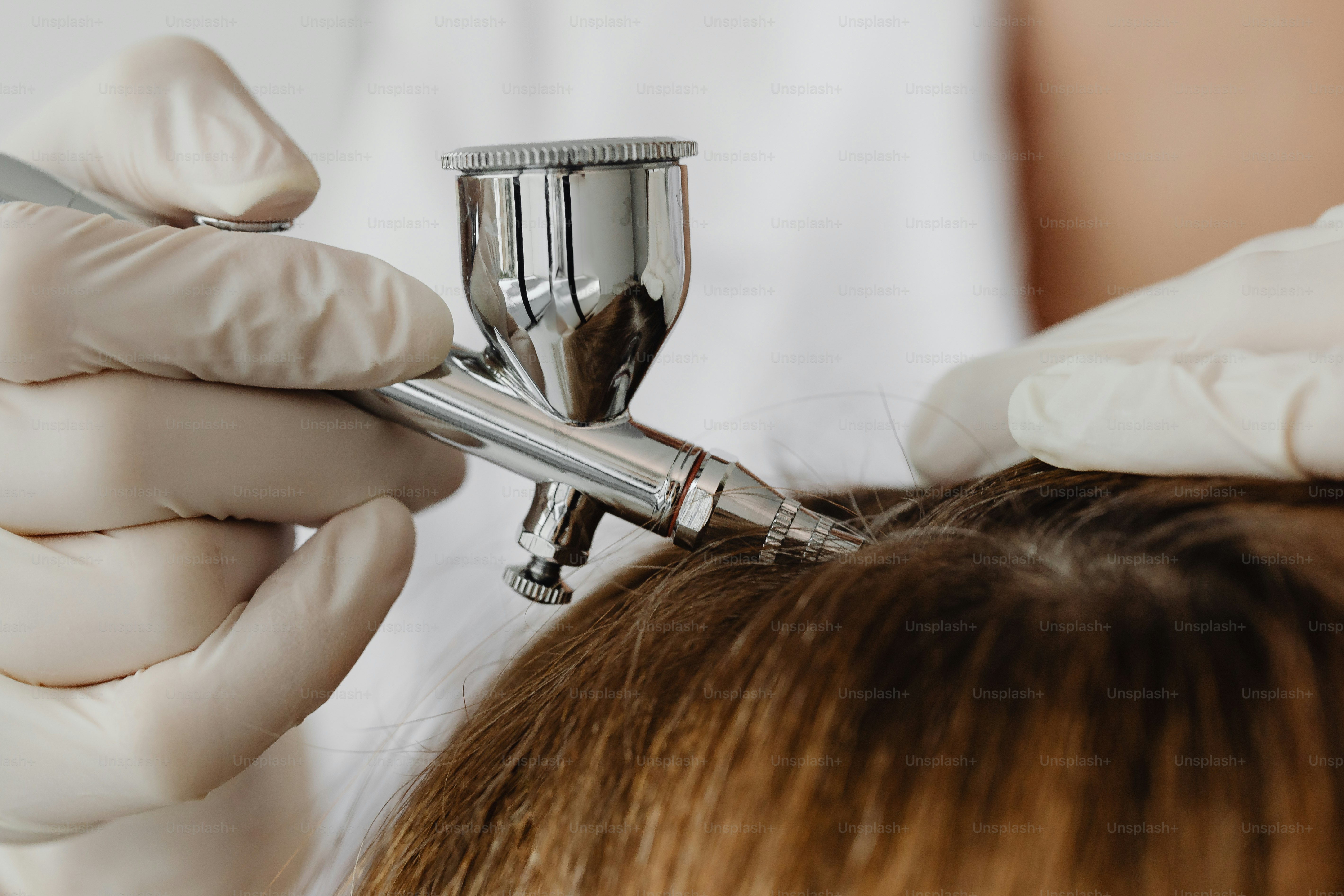 a close up of a person cutting another persons hair