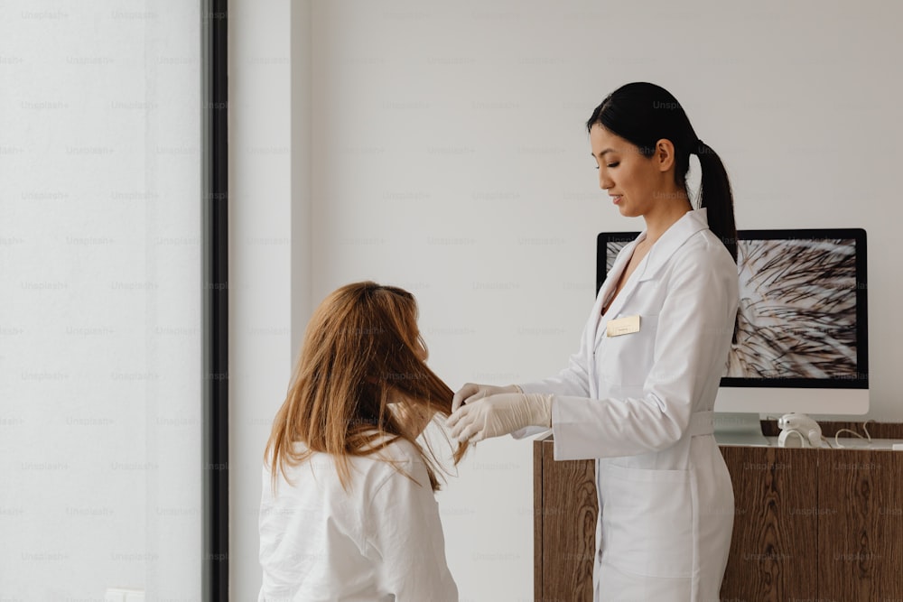 a woman in a white lab coat standing next to a woman in a white coat