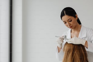 a woman getting her hair cut by a hair stylist