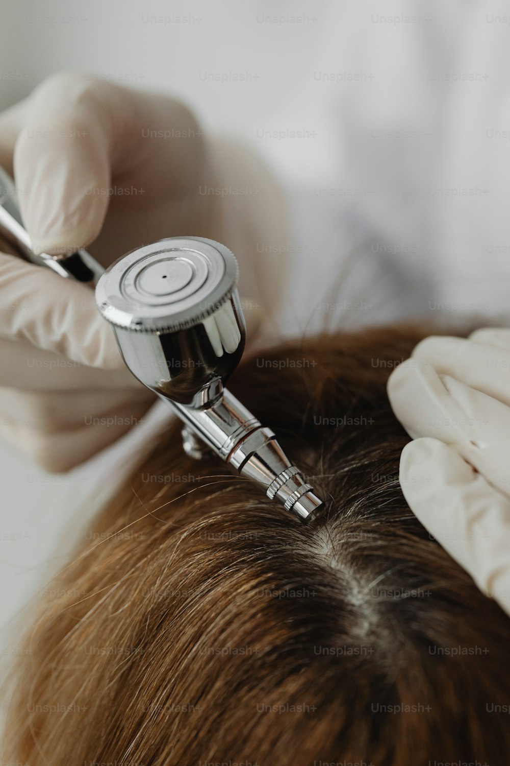 a close up of a person cutting another persons hair