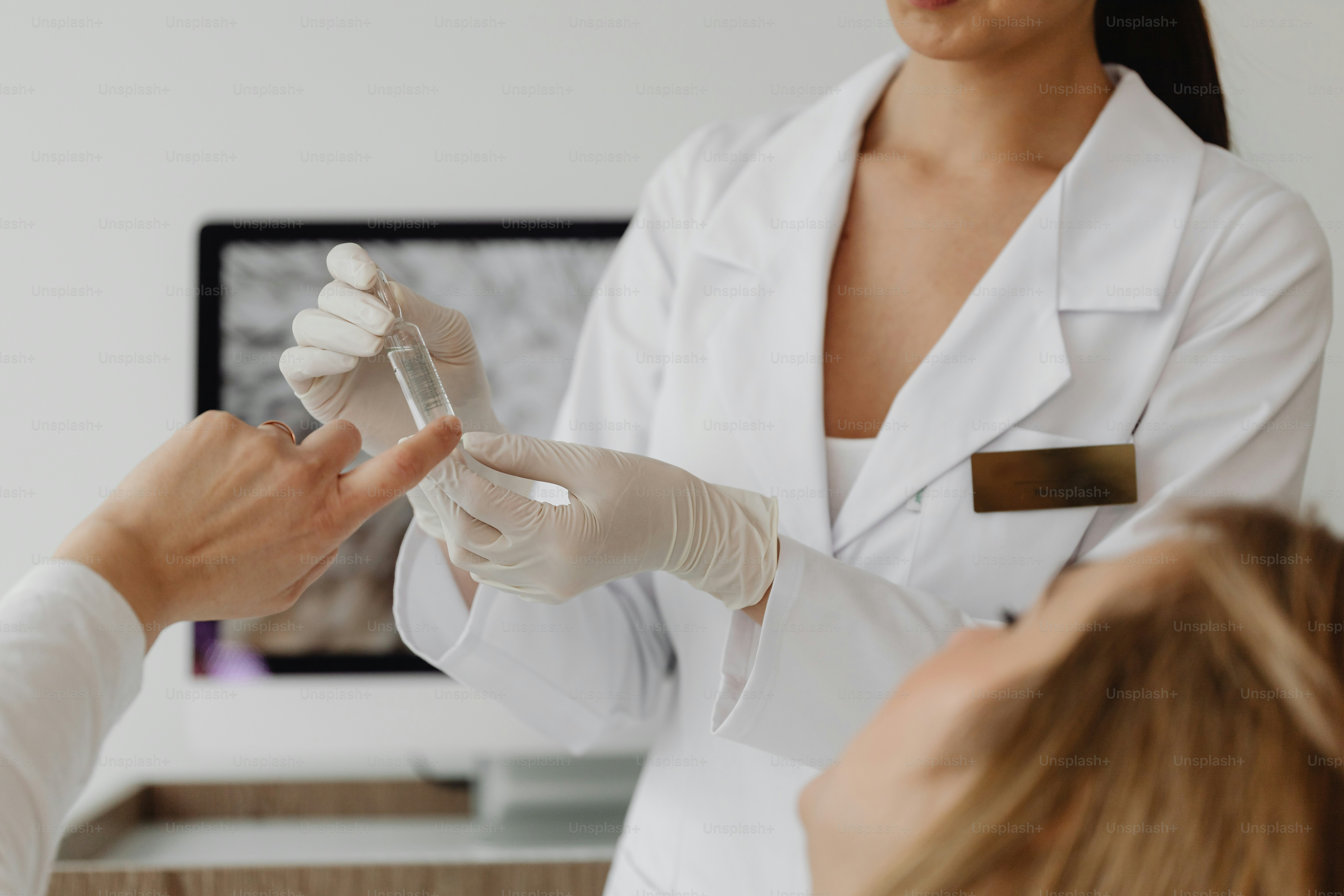 A woman getting her nails done by a doctor photo Specialist Image on