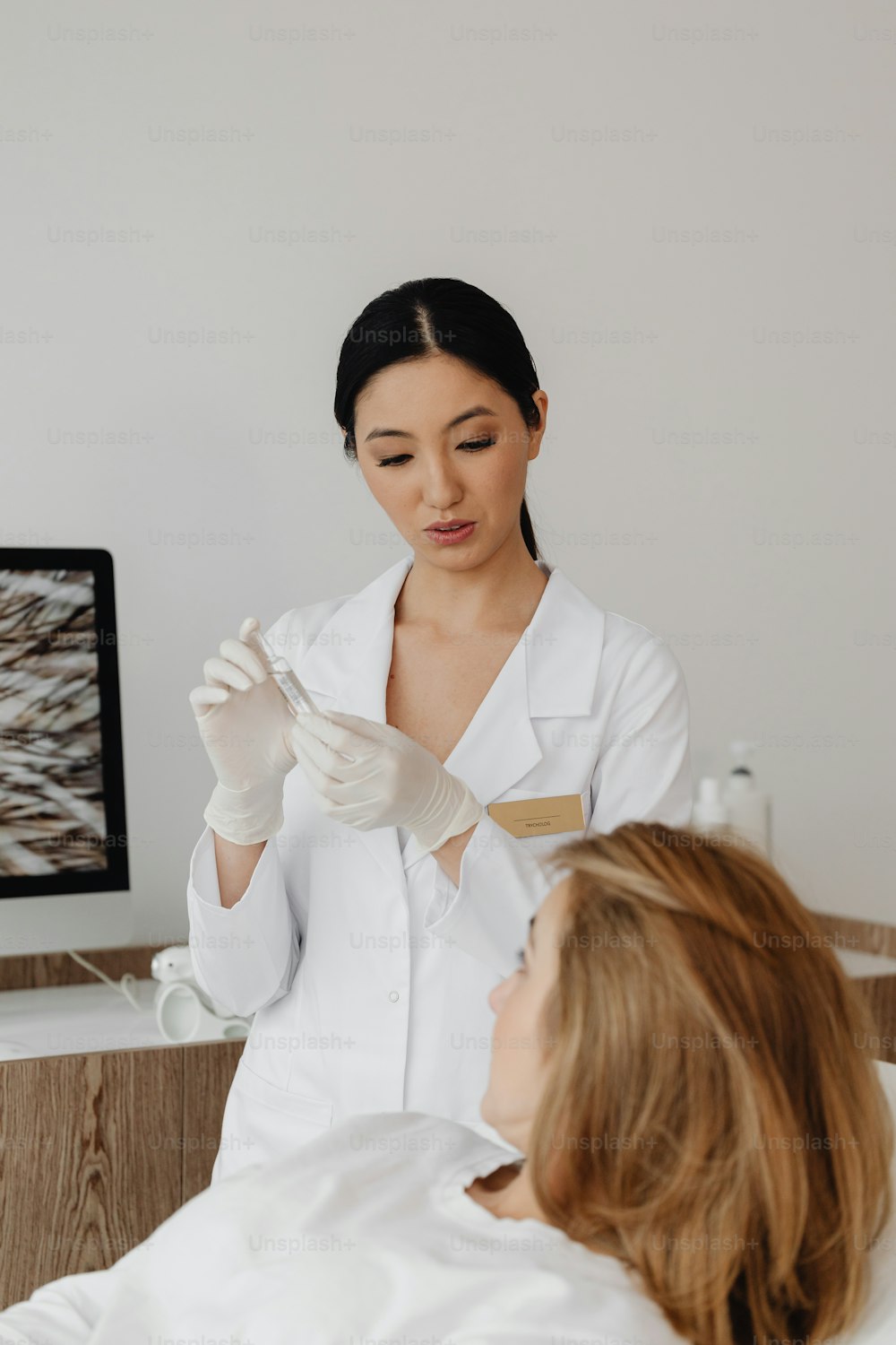 a woman in a white lab coat and gloves