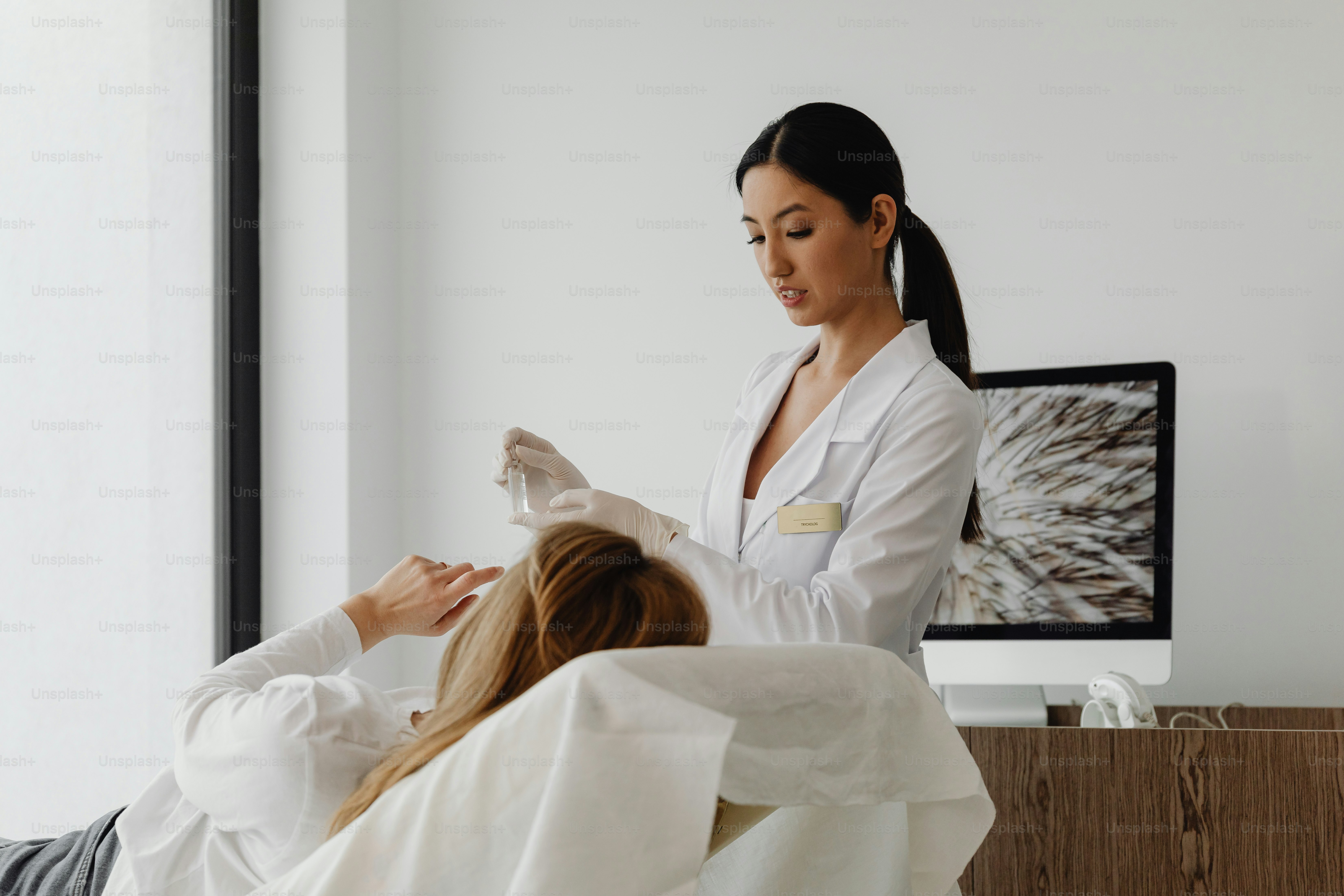 a woman getting her hair done by a hair stylist