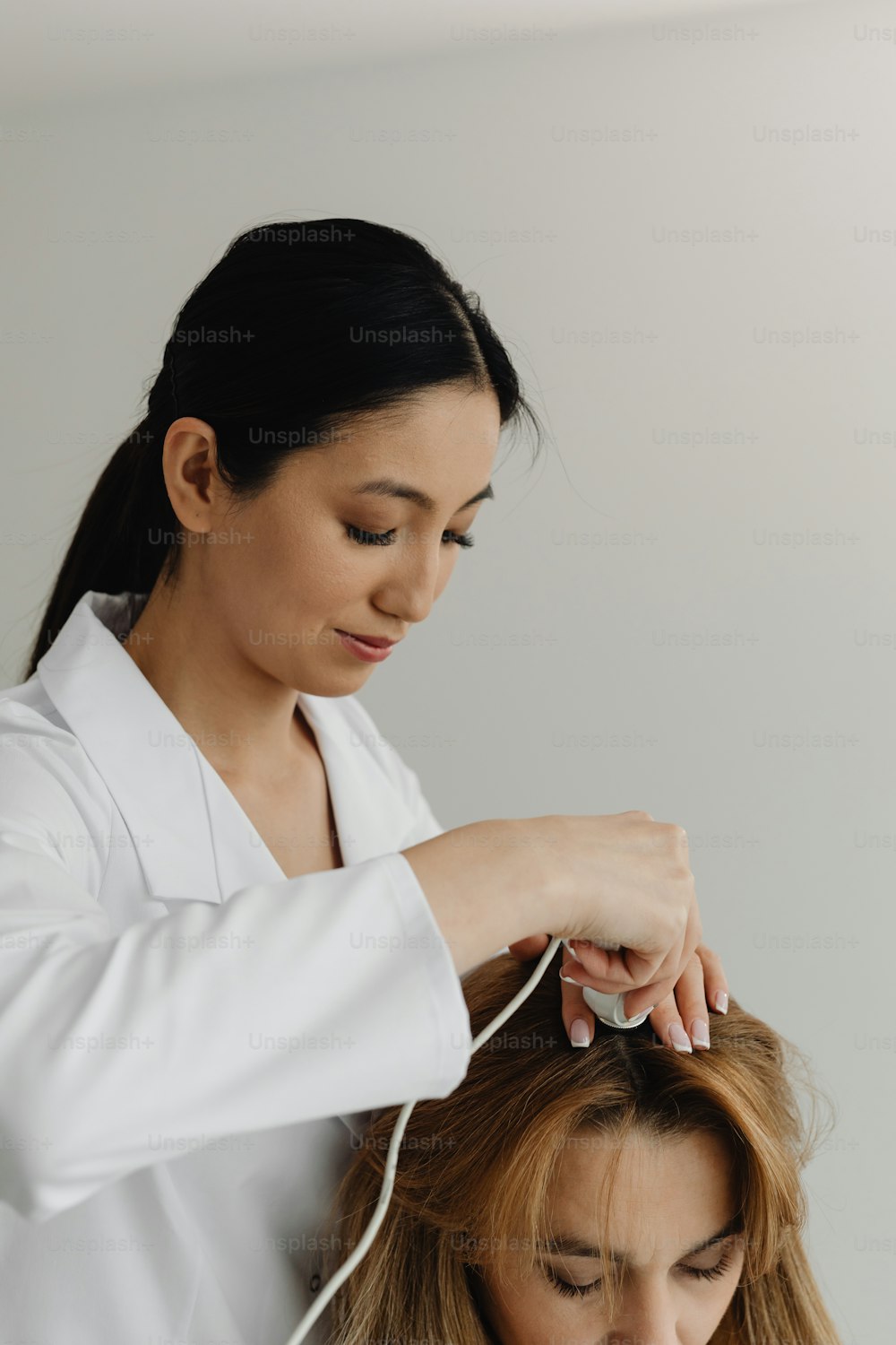 a woman getting her hair styled by a professional hair stylist