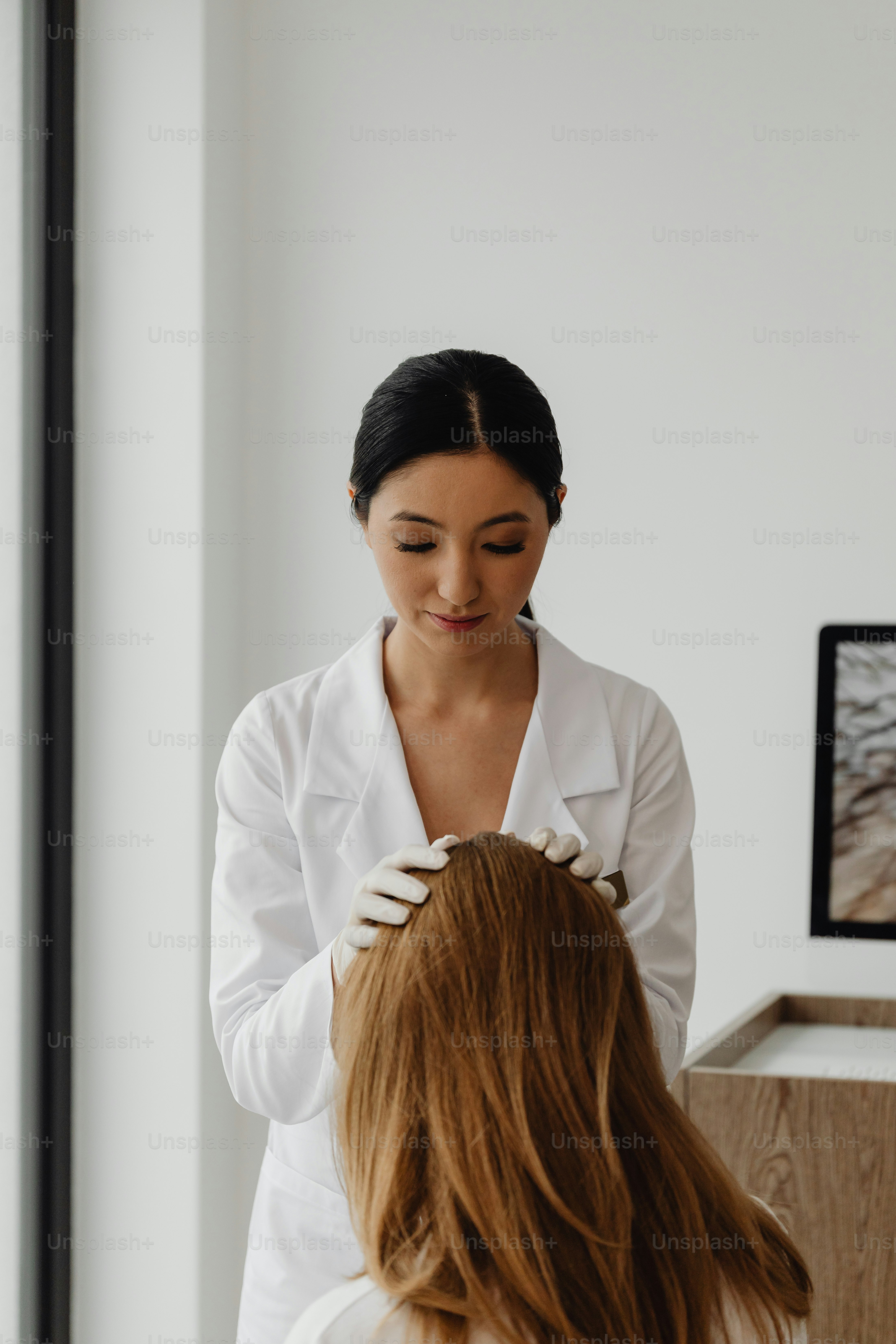 a woman getting her hair styled by a professional hair stylist
