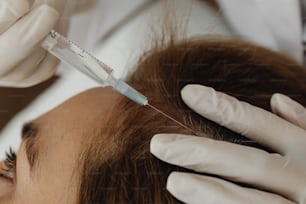 a woman getting her hair cut by a doctor