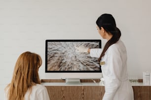 a woman standing in front of a flat screen tv