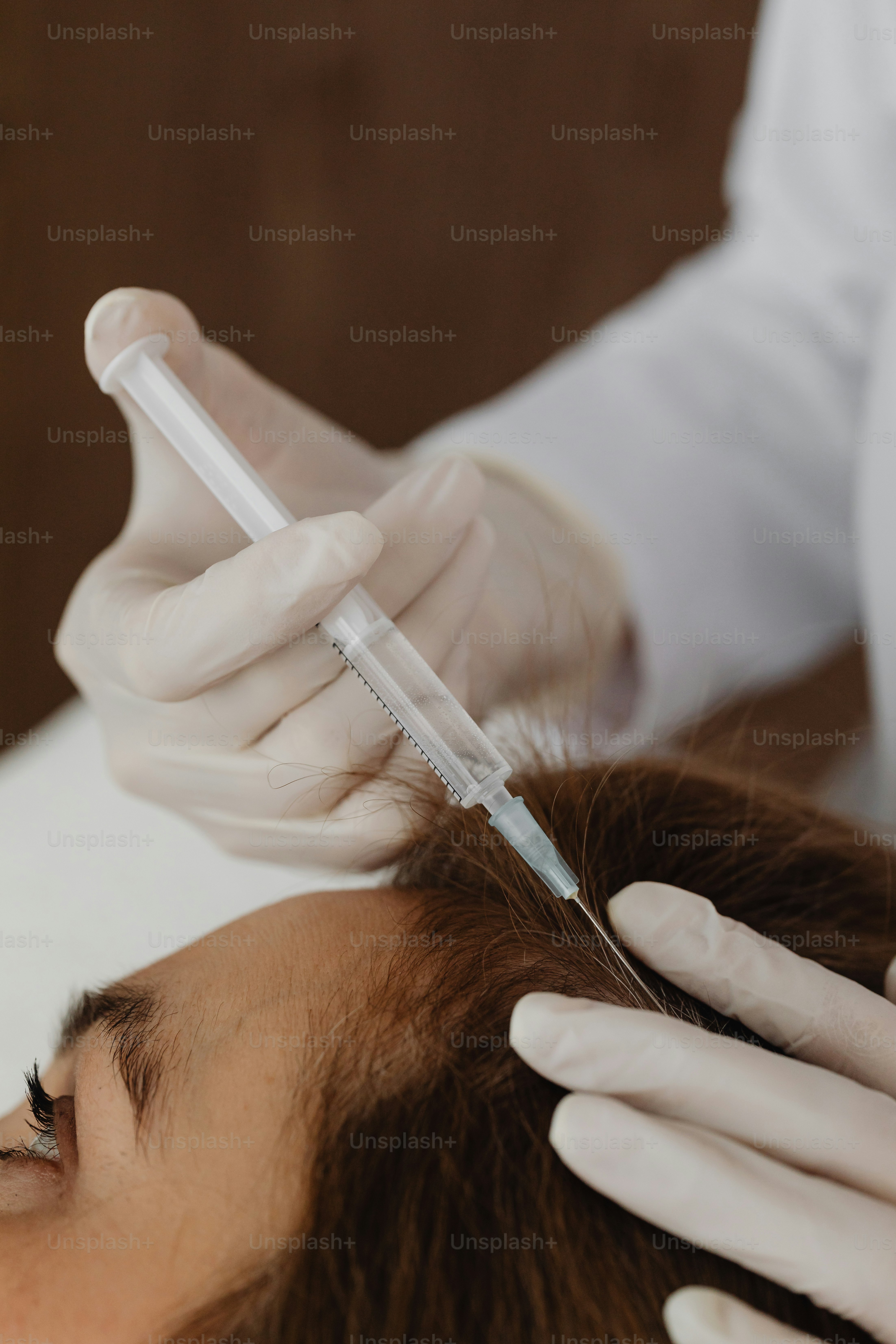 a woman getting her hair cut by a hair stylist