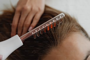 a close up of a person cutting another persons hair