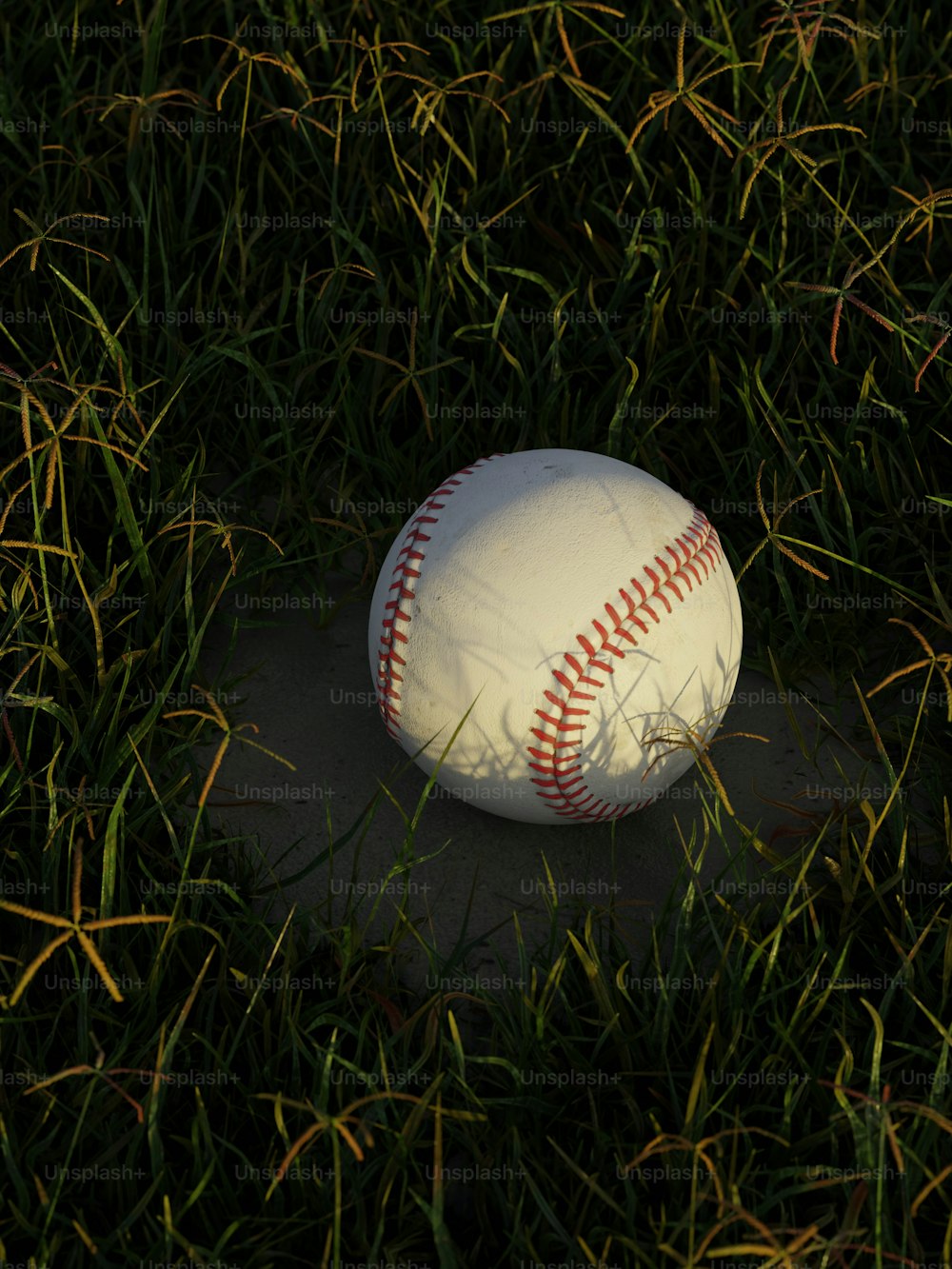 a baseball laying on the ground in the grass