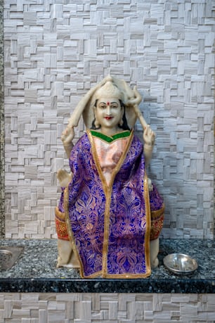 a statue of a woman in a purple dress