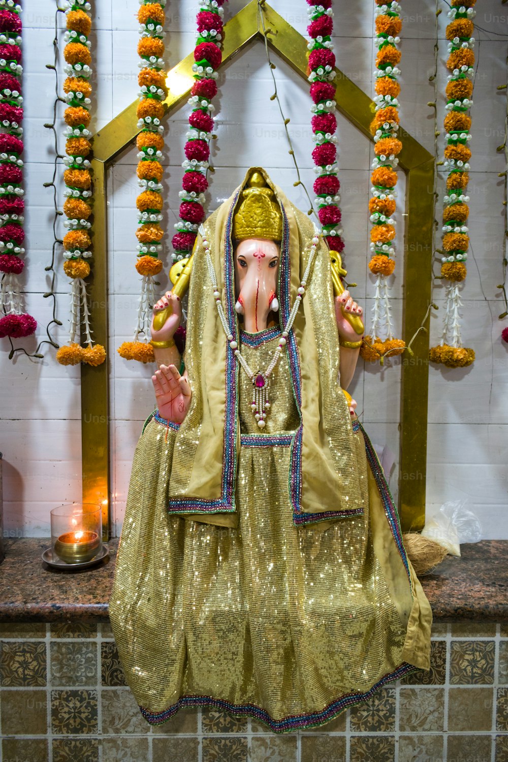a statue of an elephant wearing a golden outfit