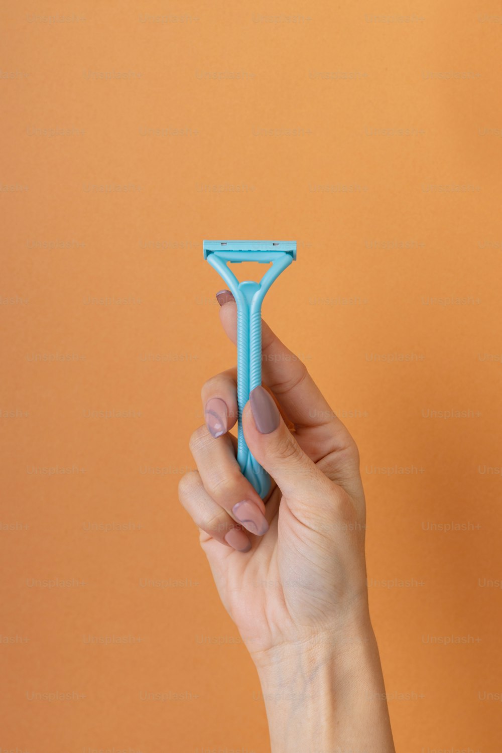 a person holding a toothbrush in their hand