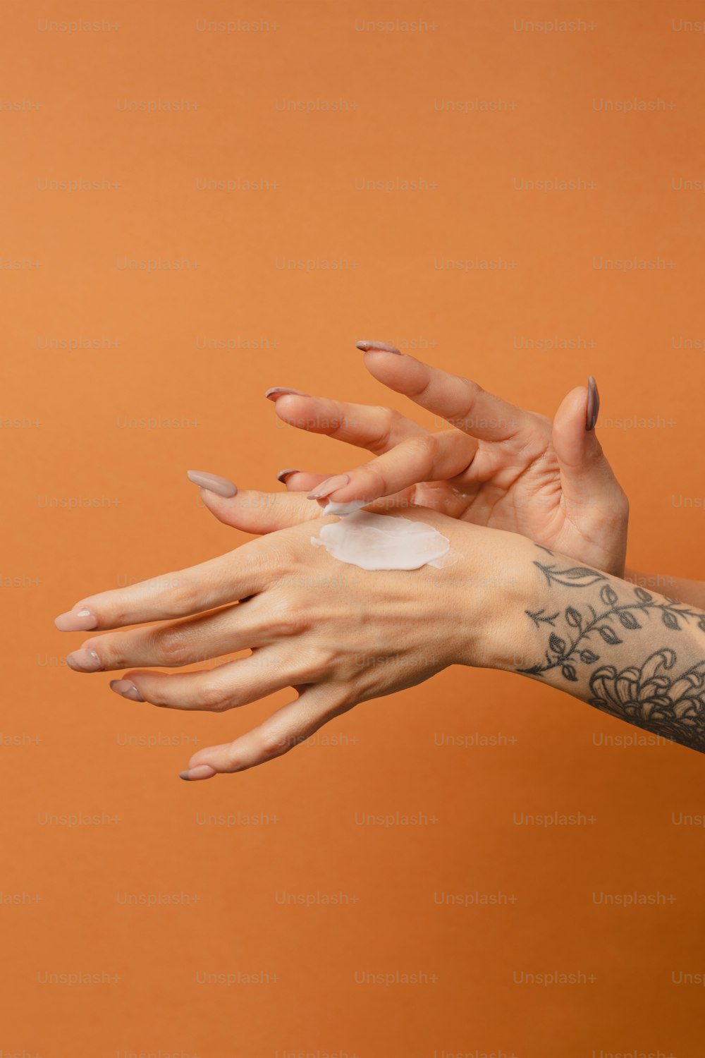 a woman's hand with a patch of cream on it