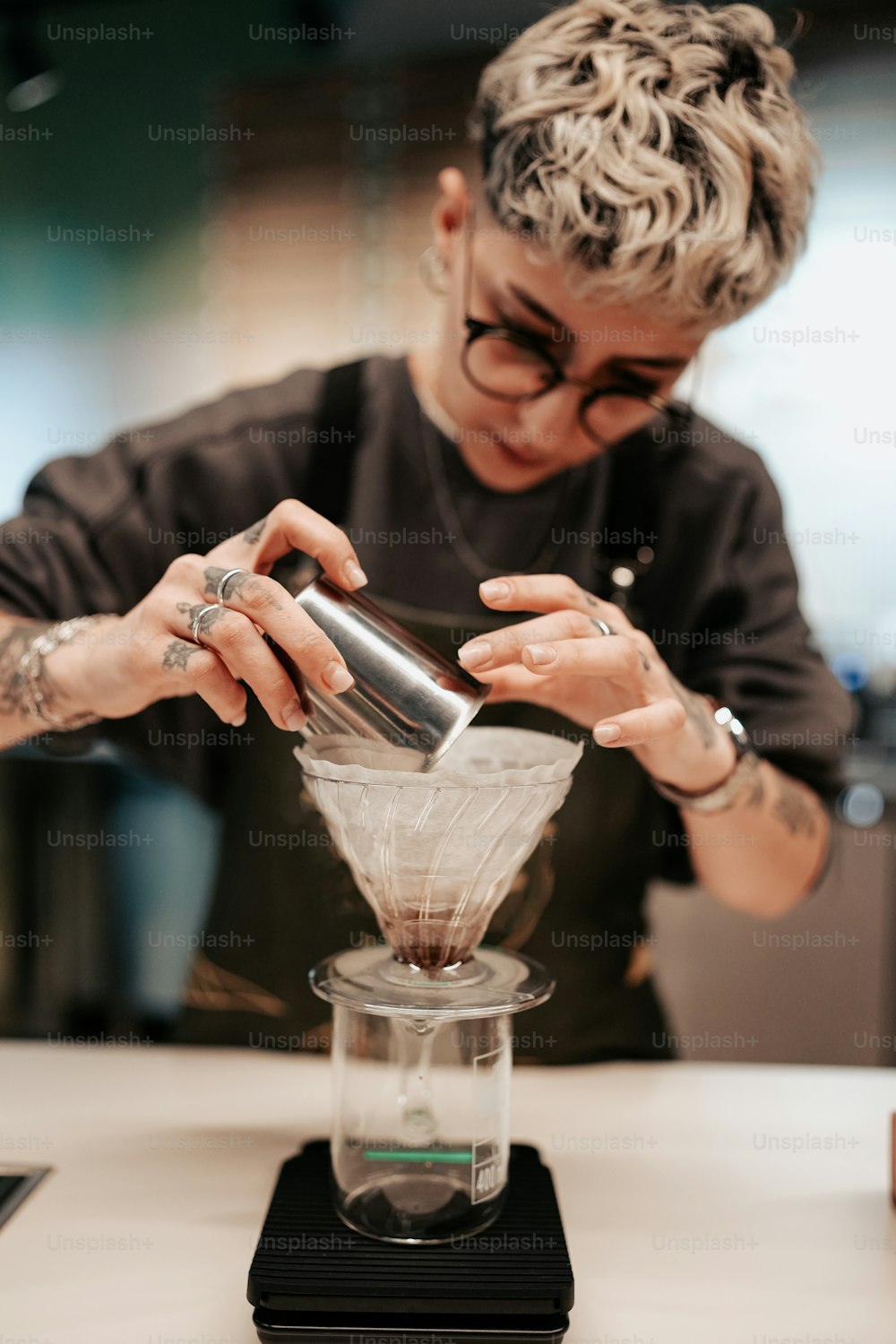 a woman pours a mixture into a blender