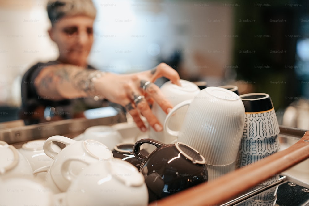 a man pouring a cup of coffee into a teapot