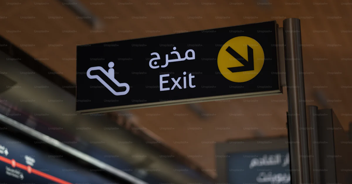 A black and yellow exit sign in a train station photo – Metro Image on ...